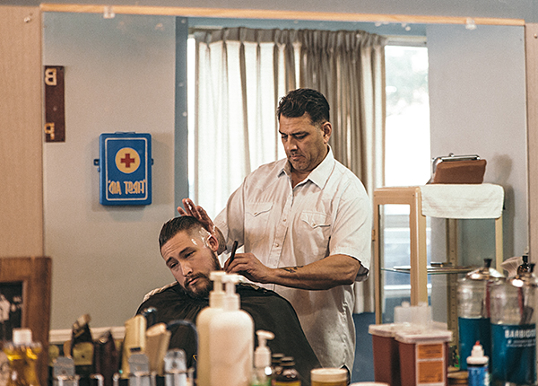 Photo of Jon Vidana cutting hair